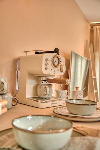 a kitchen with a microwave and bowls on a table at Suite con Jacuzzi en la montaña. in Llombay