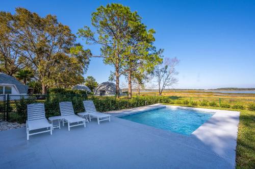 a patio with chairs and a swimming pool at Sumner Lake House 3B in Clermont