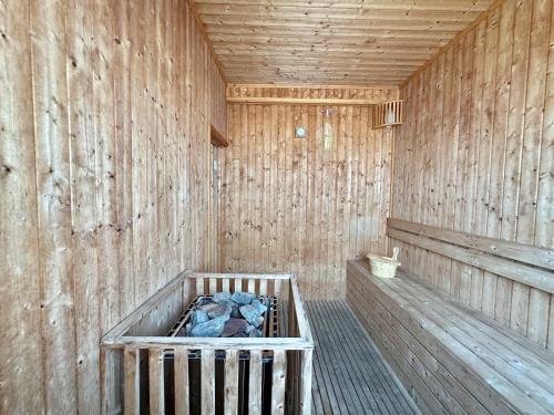 a wooden sauna with a crib in a wooden wall at Infinity 28 Hotel and Residence in Phnom Penh