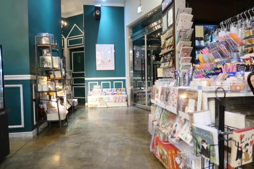 a store with blue walls and a aisle with products at Andong Poong-gyung HOSTEL n LIBRARY in Andong