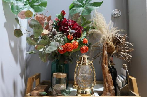 a table with two vases with flowers on it at Andong Poong-gyung HOSTEL n LIBRARY in Andong