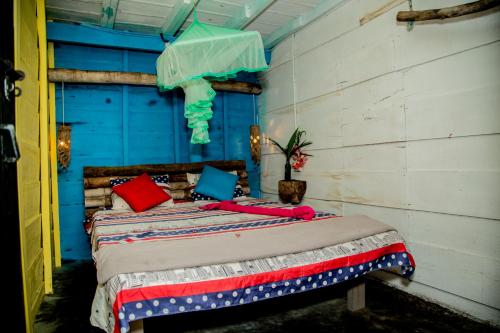a bedroom with a bed with colorful pillows at Brother's Beach Home in Galle