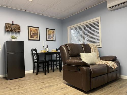 a living room with a couch and a table at Rejuvenation Cottage - Wine Country Tranquility in Temecula