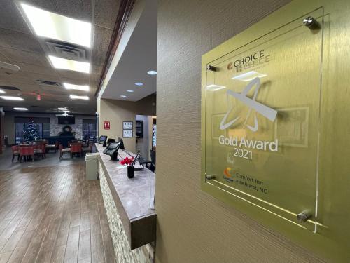 a door in a lobby with a sign on a wall at Comfort Inn Pinehurst - Southern Pines in Pinehurst