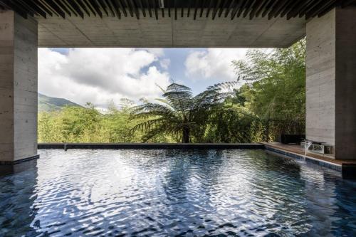 a swimming pool with a view of the jungle at Deer Chaser in Lugu