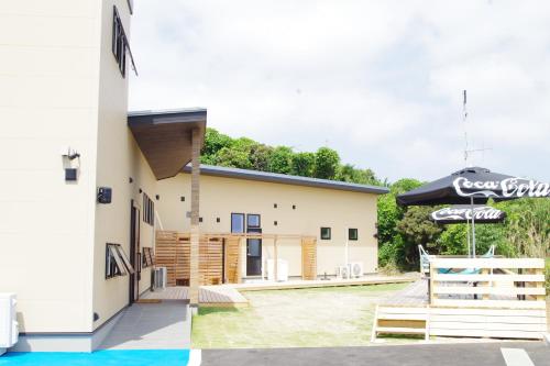 a building with an umbrella in front of it at 柏島ヴィレッジ in Otsuki