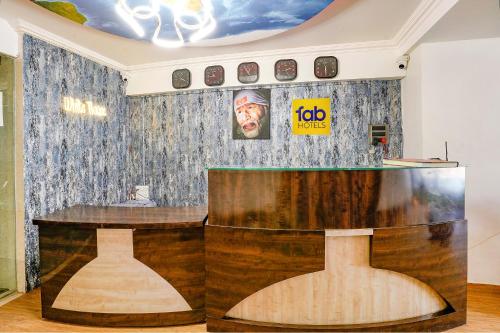 a bar in a room with a painting on the wall at Hotel White House - Nr MIDC Khargar in Koparpāda