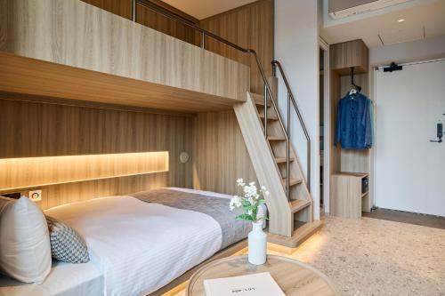 a bedroom with a bunk bed and a table at FAV TOKYO Ryogoku in Tokyo