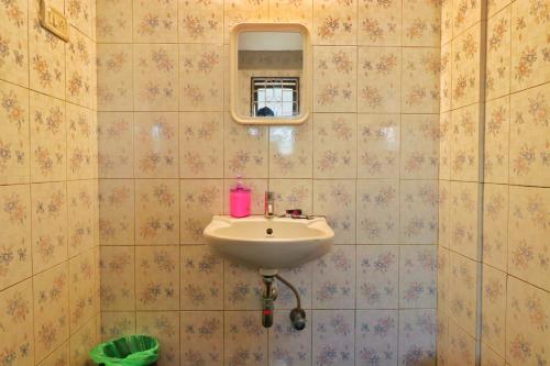 a bathroom with a sink and a mirror at Velvet Rooms By 29bungalow in Lonavala