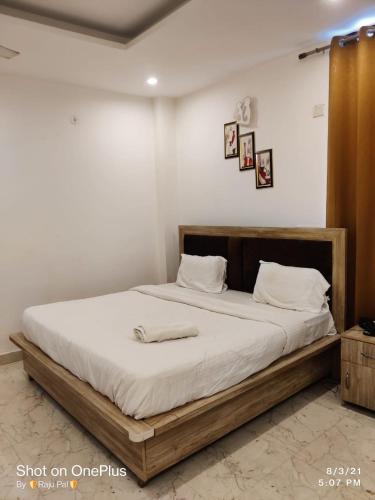 a bed with a wooden frame in a room at Hotel Rivasa Regency in New Delhi