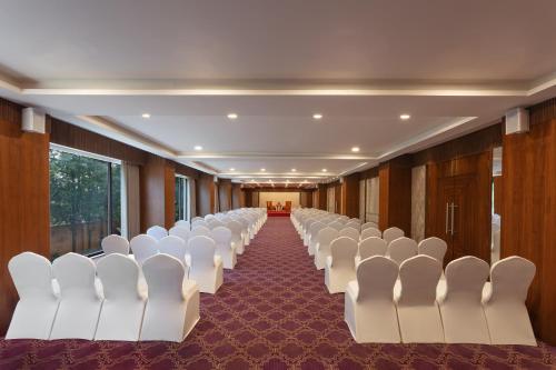 a row of white chairs in a room at Fortune Park Airport Road, Hubballi - Member ITC Hotels' Group in Hubli