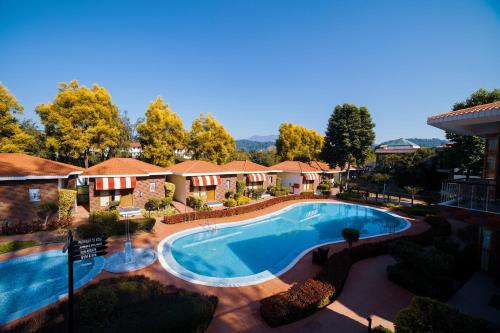 an image of a swimming pool at a resort at Country Inn Tarika Riverside Resort Jim Corbett in Garjia