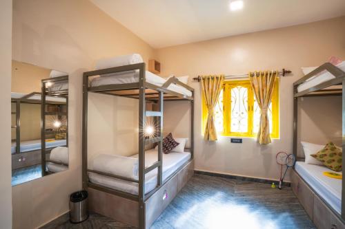 a bedroom with bunk beds in a house at Zostel Goa, Morjim in Morjim