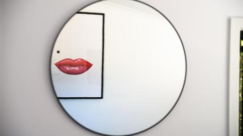 a mirror with a red lips reflection in it at LACROIX - DAYLESFORD in Daylesford