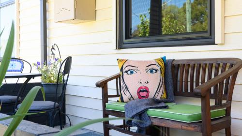 a bench with a pillow on a porch at LACROIX - DAYLESFORD in Daylesford
