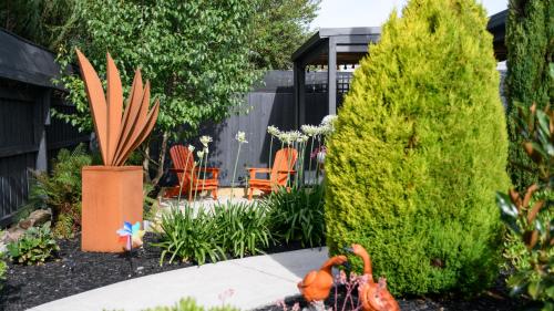 a garden with orange chairs and a potted plant at LACROIX - DAYLESFORD in Daylesford