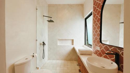 a bathroom with a toilet and a sink and a shower at Villa Sakinah Canggu in Canggu