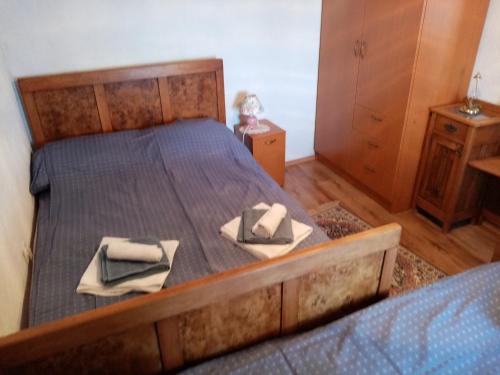 a bedroom with a bed with two towels on it at CAPITANO di CHERSO VIP holidays, gourmet & sail experience in Dragozetići