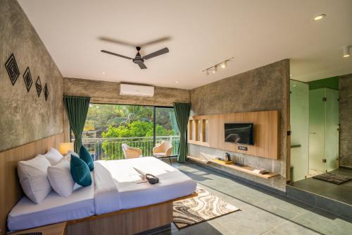 a bedroom with a king sized bed and a fireplace at Zostel Goa, Morjim in Morjim