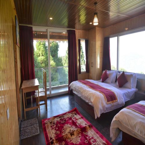 a bedroom with two beds and a large window at Amaira Resort & Farms - Mirik, West Bengal in Mirik