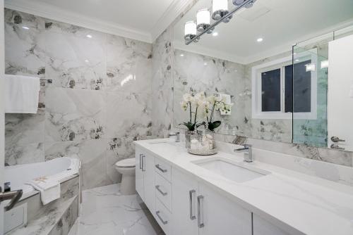 a white bathroom with a sink and a toilet at Sun suite in Surrey