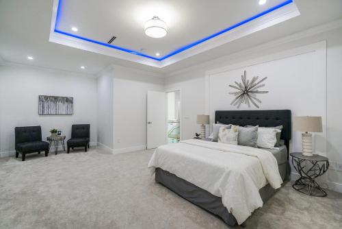 a bedroom with a large bed with a blue ceiling at Sun suite in Surrey