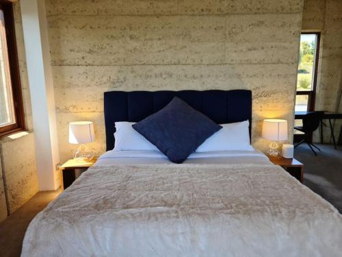 a bedroom with a large bed with two lamps at Little Cuttlefish on Kangaroo Island in Penneshaw