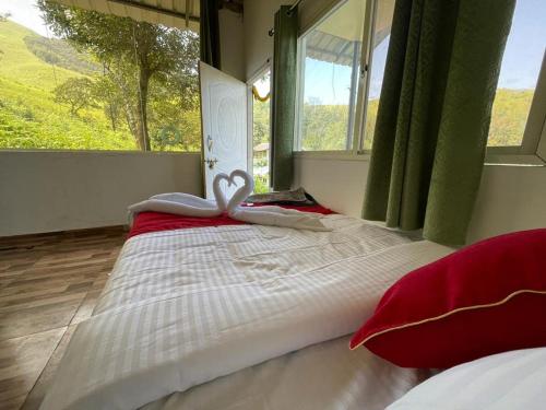 a large bed in a room with a window at Kanasucoffeenadu in Attigundi