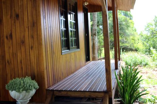 a porch of a house with a wooden deck at Cabana na Serra Gaúcha! in Picada Cafe