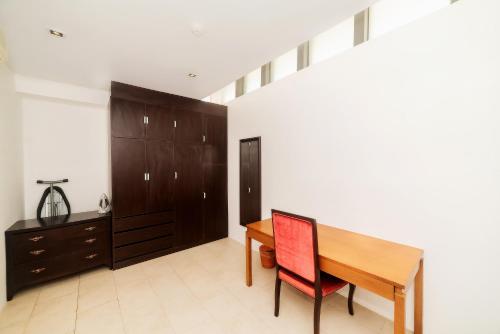 a room with a wooden table and a desk at The Ocean Villas Managed by The Ocean Resort in Da Nang
