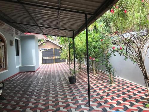 um quarto com um pátio com piso em tijolo e plantas em MSV Villa résidence home em Batticaloa