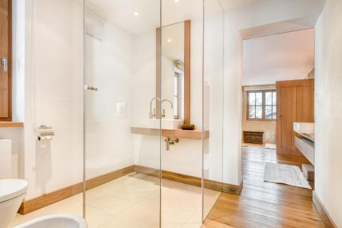 a bathroom with a glass shower and a toilet at Chalet Lilly - Family and Friends by A-Appartments mit Ski in - Ski out in Zug