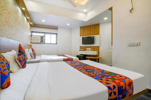 a bedroom with a large bed in a room at FabExpress Galaxy Stay - Nr Morya Hospital in Pune