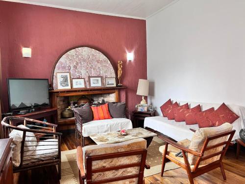 a living room with a couch and a tv at Bed&Breakfast VANILLA in Antsirabe