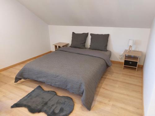 um quarto com uma cama e piso em madeira em Famille House 201 em Chalon-sur-Saône
