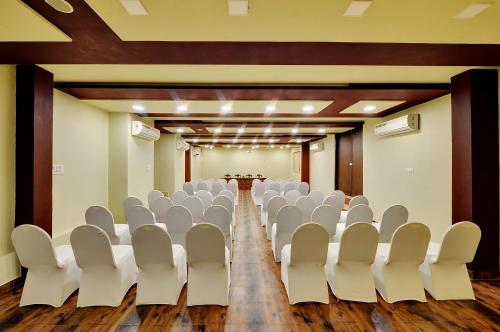 an empty conference room with white chairs in it at Padmini Bagh Resort by Inventree, Udaipur in Udaipur