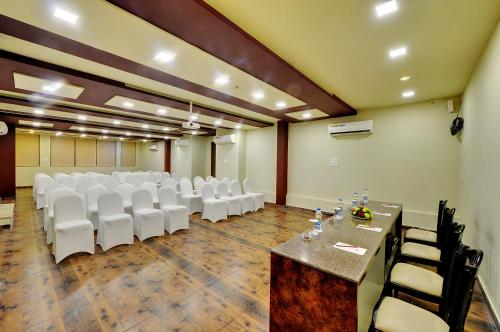 a conference room with white chairs and a table in it at Padmini Bagh Resort by Inventree, Udaipur in Udaipur
