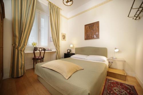a bedroom with a bed and a window at Residenza Le 6 A in Trieste