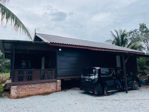 a car parked in front of a house at NAZIRIN HOMESTAY D’VILLAGE MUAR BATU PAHAT in Semerah