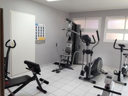 a gym with several exercise equipment in a room at Hôtel Calme Des Pins & Spa in Les Sables-d'Olonne