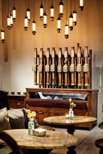 a room with a large group of bottles on the wall at Telegraphenamt in Berlin