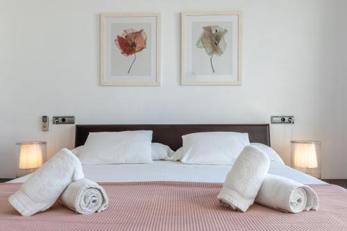 a bedroom with a bed with towels on it at Apartment La Nau - Fantastic Apartment with hot tub and pool, just steps away from beach in Port de Pollensa