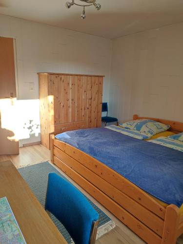 a bedroom with a large bed with a wooden headboard at Surek in Soltau