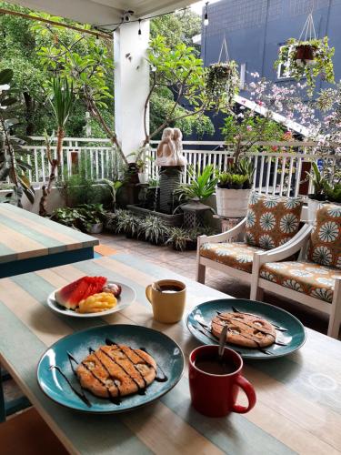 a table with two plates of food on it at INNI Homestay in Malang