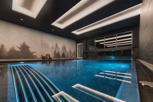 - une grande piscine dans une maison avec une piscine dans l'établissement Alpine Resort Sportalm, à Sankt Leonhard im Pitztal
