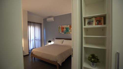 a bedroom with a bed and a book shelf at Mi Tierra Luxury Apartments in Palermo
