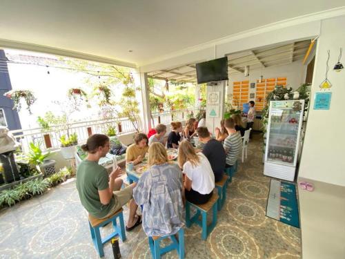 a group of people sitting at a table in a restaurant at INNI Homestay in Malang