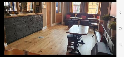 a room with tables and chairs in a restaurant at Bold Arms in Beaumaris