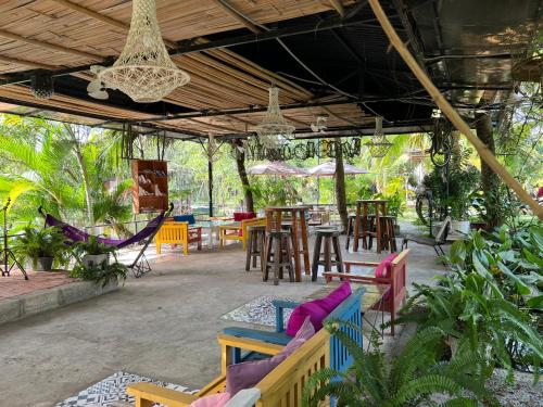 a patio with colorful chairs and tables and chairs at LAGI FARMSTAY in La Gi