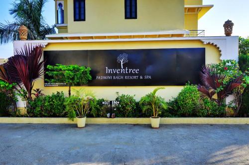 a store front with plants in front of a building at Padmini Bagh Resort by Inventree, Udaipur in Udaipur